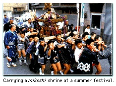 Carrying a mikoshi shrine at a summer festival.