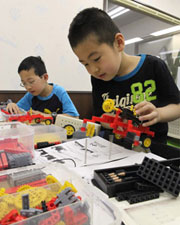 Learning to make robots is all the rage. Here, boys make robots from a range of colorful parts. (Tokyo-based cram school Blue Planet)