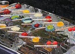 Cool fruit candies lined up on top of ice