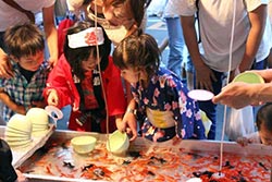 Children scooping goldfish