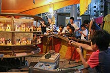 Little boy aiming at a prize with a cork pistol