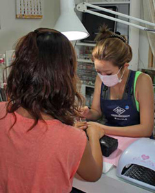 A manicurist grooms the fingertips, taking her time in a calming atmosphere. (Courtesy of: “CLEVER”Nail Salon)