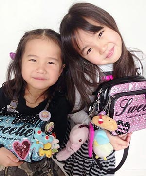 Sisters having fun with trends by attaching various straps to their bags.