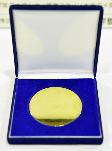 A gold medal made from scrap metal collected from small, disused household appliances