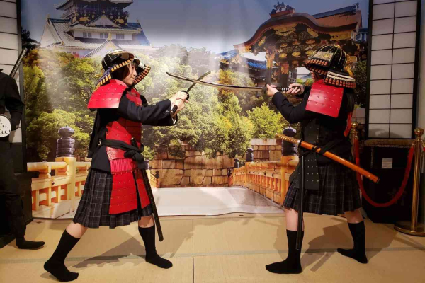 Students having fun with hands-on experiences with equipment used by samurai and ninja.