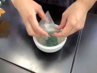 Students in a prep study session. They crush stones into powder, and then mix the powder into glue to create paint for coloring pictures.