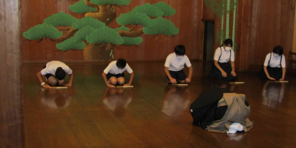 Students being taught by a Noh actor during a school trip.