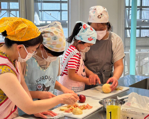 Visitors taking on a challenge to cook with freshly picked peaches.