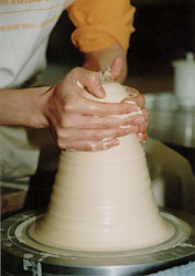 Raising the clay on the potter's wheel.