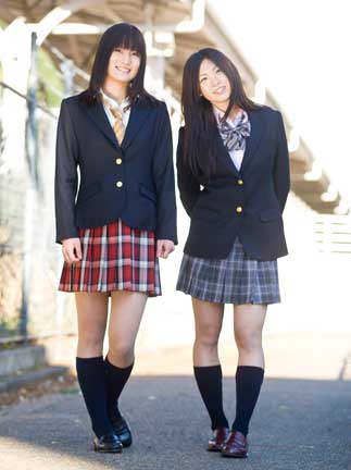 Two girls in "just kidding" school uniforms. (C) arCONOMi