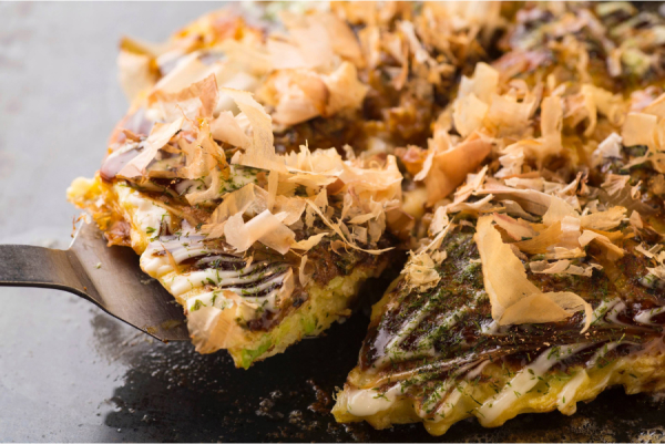 Un okonomiyaki, con su masa hecha a la plancha, se combina con los ingredientes que uno prefiera.