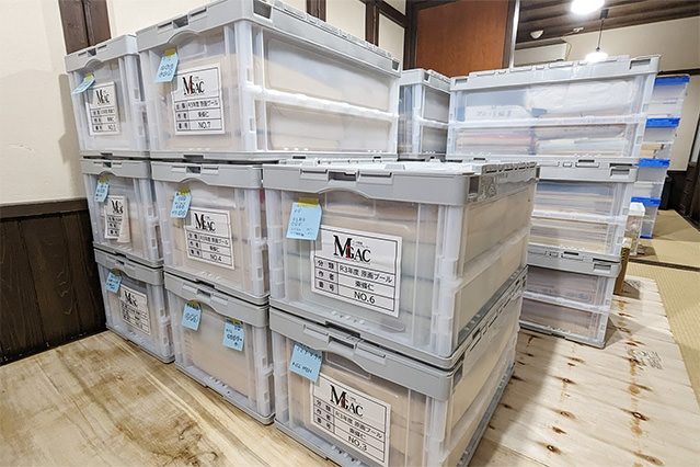 Interior storage room at the Manga Genga Archive Center with labeled archival boxes used for temporary manga storage