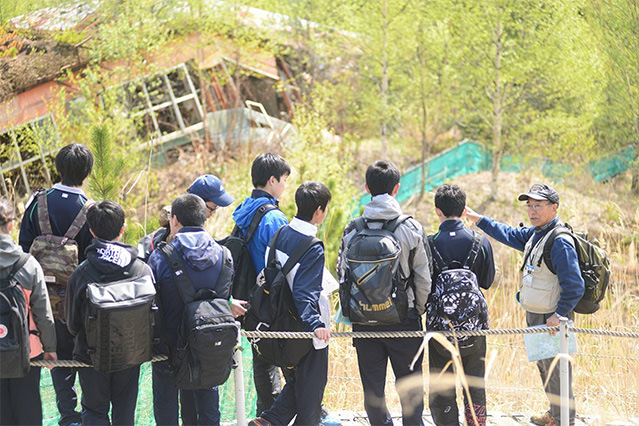 Guides lead visitors around areas affected by the 2000 eruption of Mount Usu.