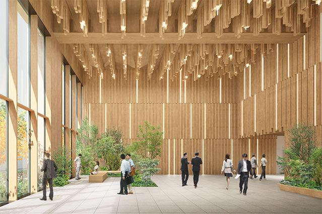Large wood-paneled interior space with high ceilings, integrated greenery, and people walking through a bright, open workplace area
