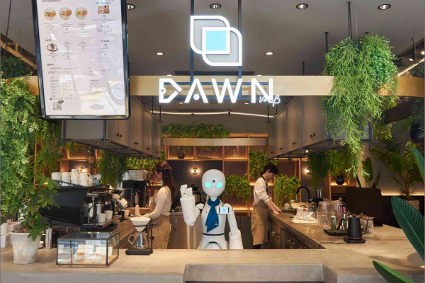 An avatar robot greets customers at the entrance to the cafe.